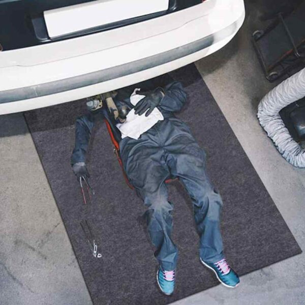 Mechanic using the mat automotive work mat